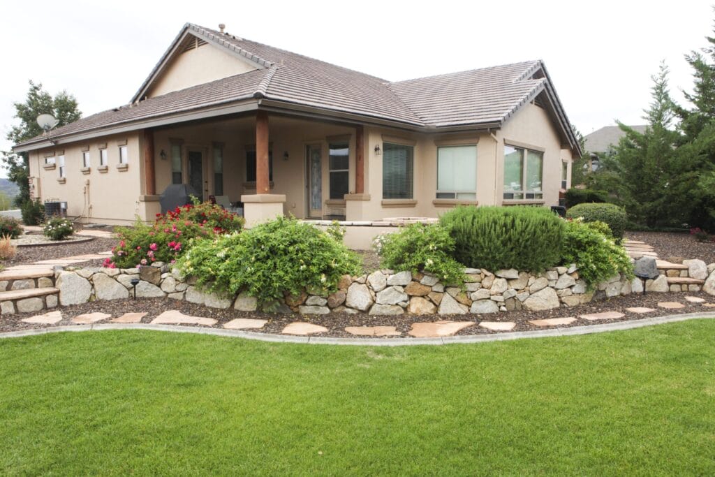 This backyard transformation features turf, hardscape, and landscape installation