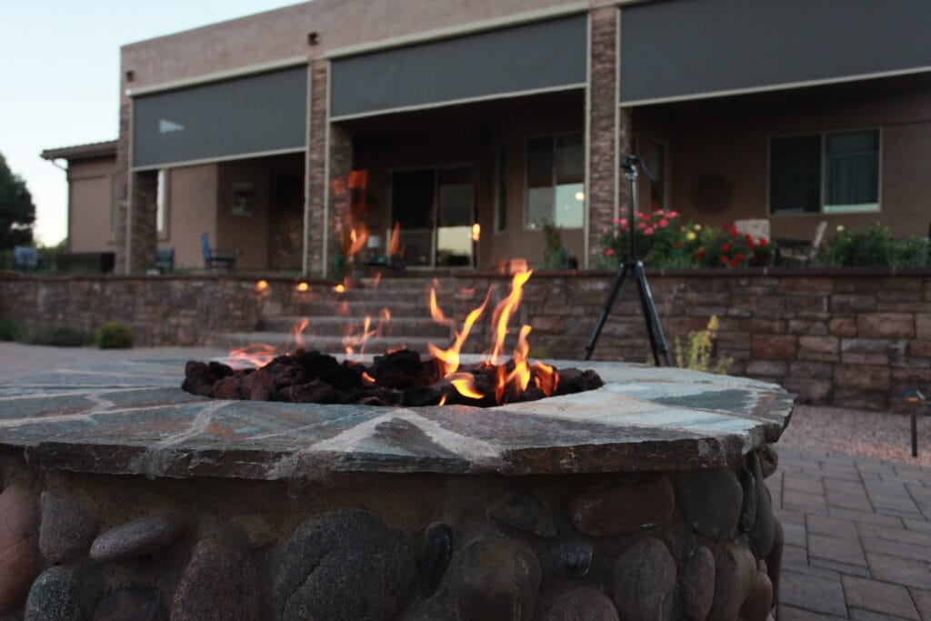 Cusotm fire pit lit up to provide a warm, cozy atmosphere