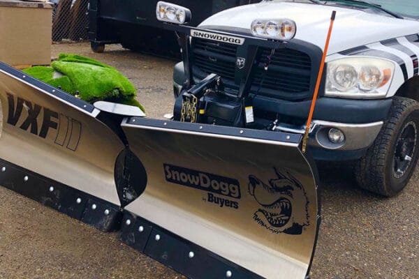 a Zebrascapes truck outfitted with snow plows for commercial snow removal