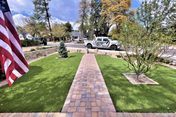 Zebrascapes truck in front of a lawn where they have just completed landscape cleanup and maintenance services