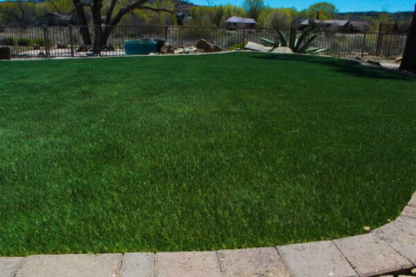 Lush, dark green turf surrounded by a stone barrier