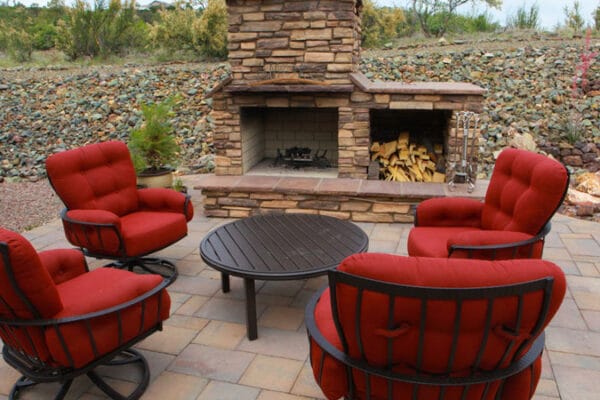 the seating area and outdoor fireplace in a Zebrascapes custom designed outdoor living space