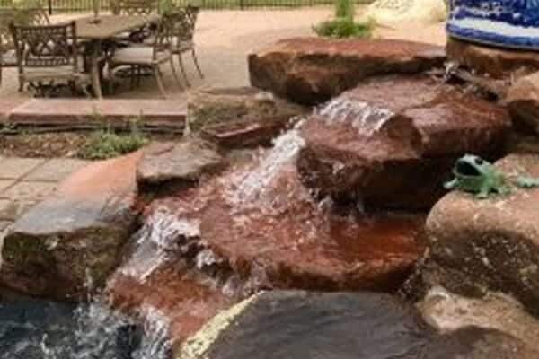 a custom water feature designed and installed by Zebrascapes as part of an outdoor living area