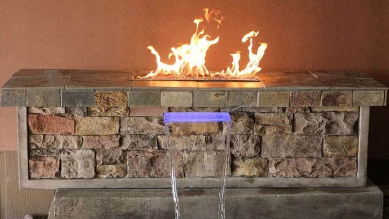 A tabletop outdoor fireplace designed and installed by Zebrascapes landscaping