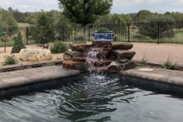 An outdoor water feature/backyard hot tub designed and installed by Zebrascapes landscaping - Chino Valley