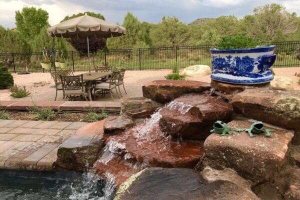 backyard water feature (close-up) sitting above a custom hot tub as part of an outdoor living area designed and installed by Zebrascapes
