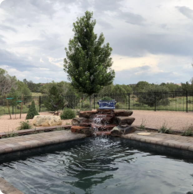 Zebrascapes' home swimming pool design incorporates water features, hardscapes, and native landscaping