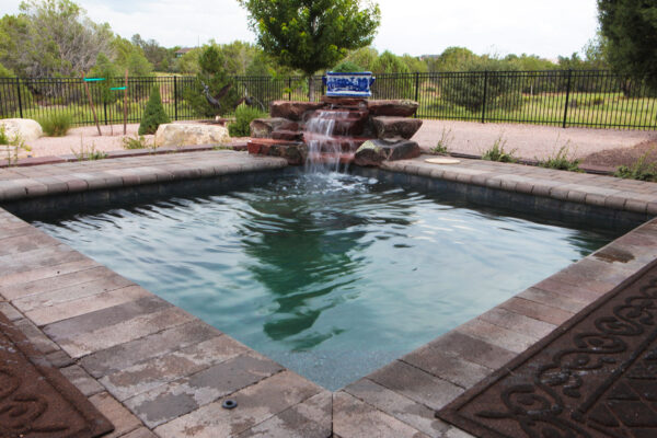 Zebrascapes pool design featuring square pool with custom masonry and hardscape features