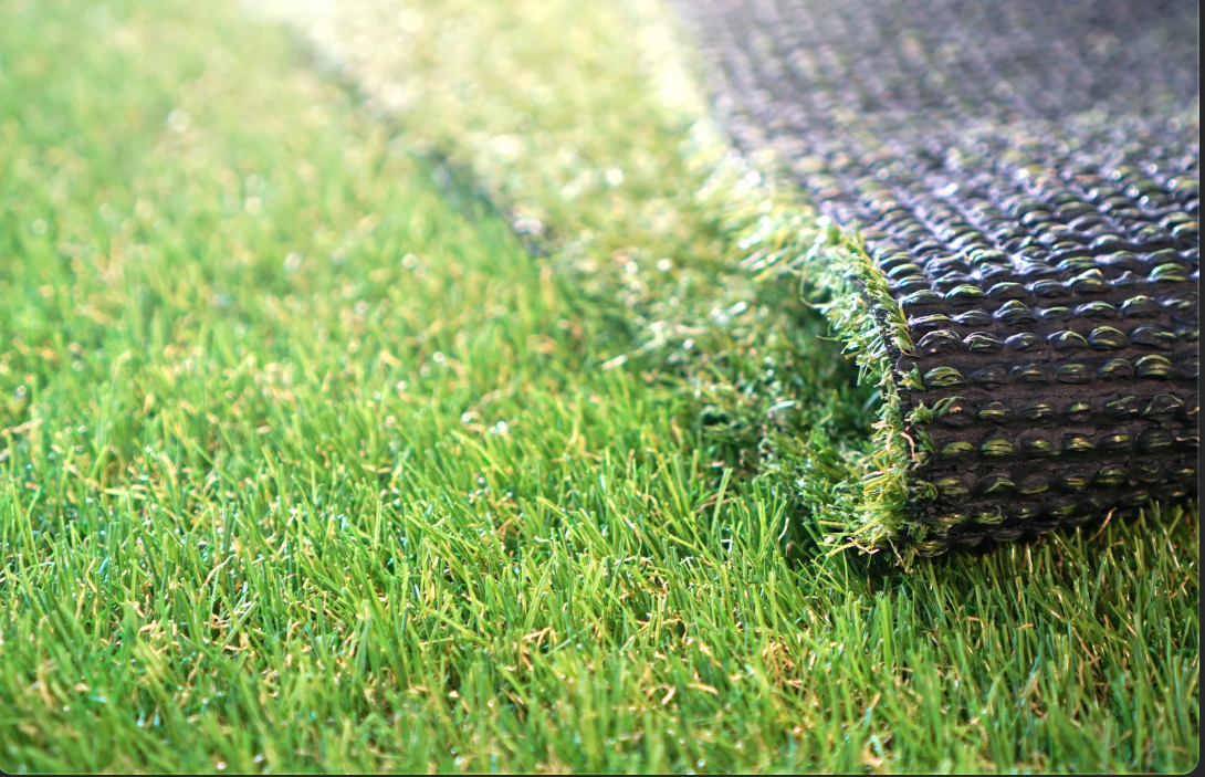 a close up of artificial turf showing the turf and the drainage mat